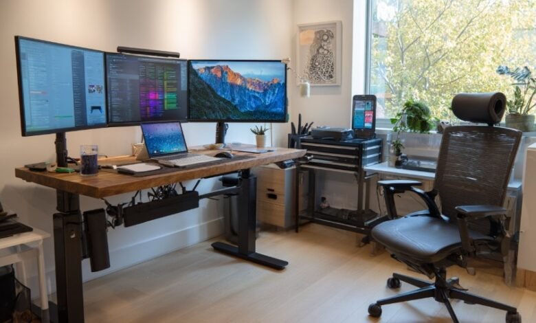 Ergonomic home office setup with standing desk, office chair, and dual monitors